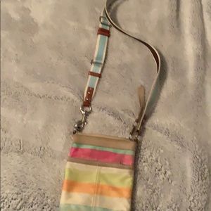 A used striped coach bag.